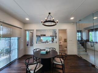 Contemporary dining area with round table and modern chandelier