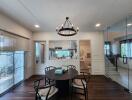 Contemporary dining area with round table and modern chandelier