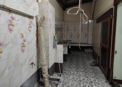 View of a kitchen space with tiled walls and flooring