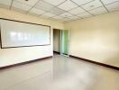 Empty office space with whiteboard and glass door