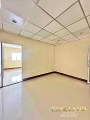 Spacious living room with window and light-colored walls