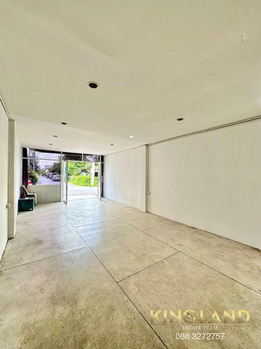 Empty main living space with large windows