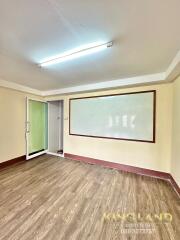 Empty room with wooden flooring and whiteboard