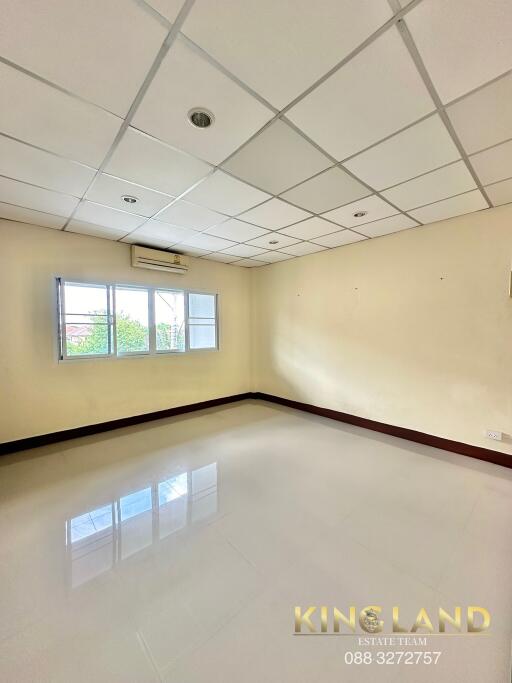 Spacious and brightly lit living room with tiled flooring and large windows