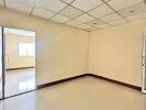 Empty room with tiled ceiling and glass door