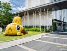 Modern building facade with unique yellow sculpture