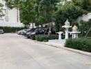 Parking area with parked cars and a small shrine