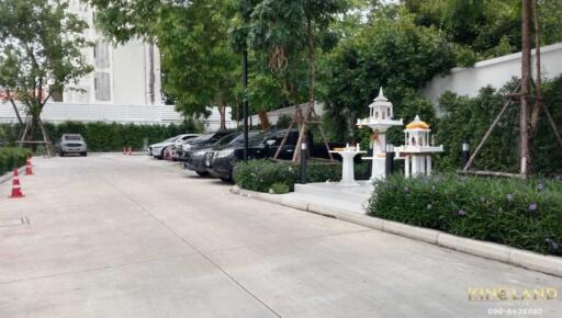 Parking area with parked cars and a small shrine