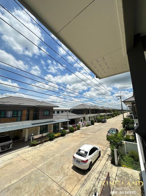 View of a residential street with houses and a parked car