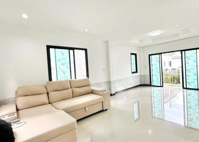 spacious living room with large windows and comfortable sectional sofa