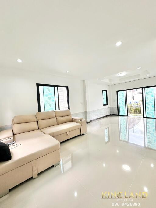 spacious living room with large windows and comfortable sectional sofa