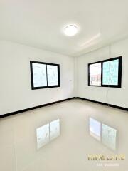 Bright, unfurnished bedroom with windows