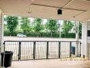 Covered outdoor patio with view of the street and greenery