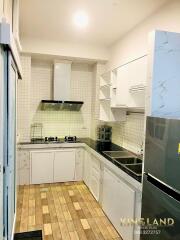 Modern kitchen with tiled backsplash and wooden flooring