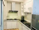 Modern kitchen with tiled backsplash and wooden flooring