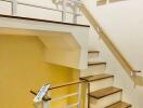 Indoor staircase area with wooden steps and white railings