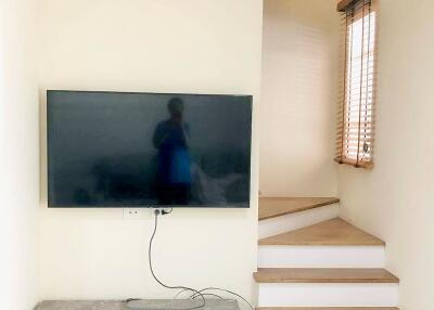 Living area with TV and staircase