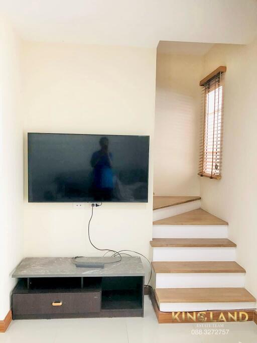 Living area with TV and staircase