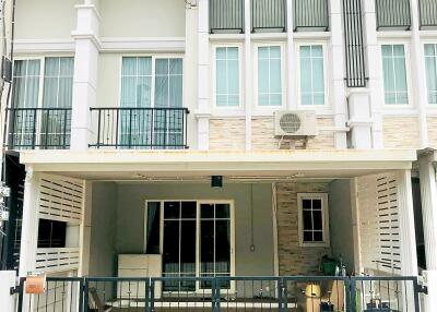 Two-story townhouse facade with balcony and garage