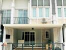 Two-story townhouse facade with balcony and garage