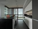 Modern kitchen with large windows and laundry area