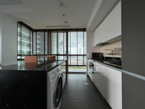 Modern kitchen with large windows and laundry area