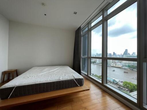 Spacious bedroom with large windows and city view