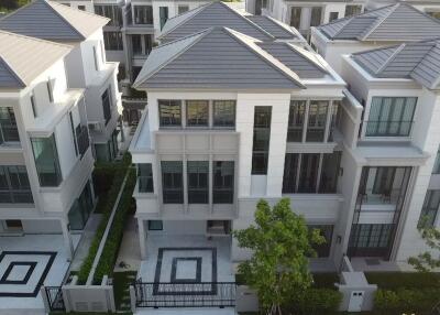 Aerial view of modern multi-story homes with symmetrical design