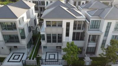 Aerial view of modern multi-story homes with symmetrical design