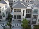 Aerial view of modern multi-story homes with symmetrical design