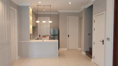 Modern kitchen with white cabinetry and stainless steel appliances