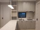 Modern kitchen with white cabinetry and pendant lighting