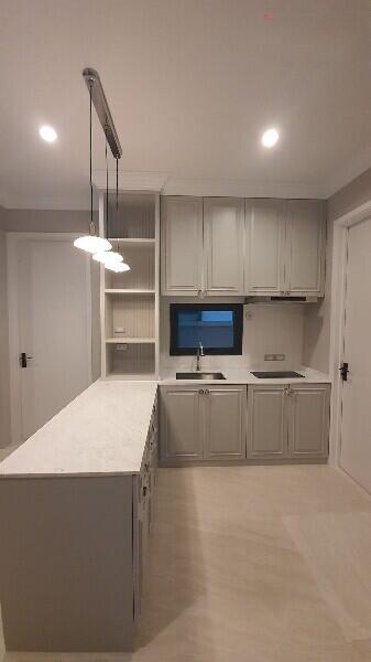 Modern kitchen with white cabinetry and pendant lighting