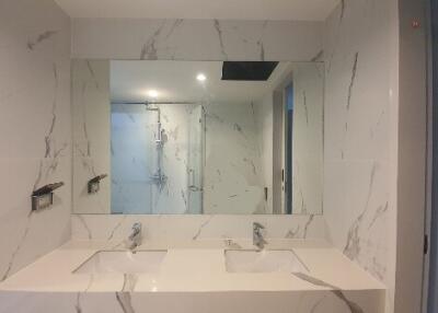 Modern bathroom with dual sinks and large mirror