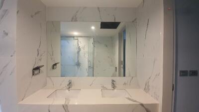 Modern bathroom with dual sinks and large mirror