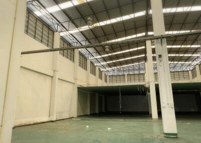 Large empty warehouse interior with high ceiling