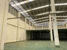 Large empty warehouse interior with high ceiling