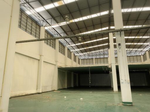 Large empty warehouse interior with high ceiling