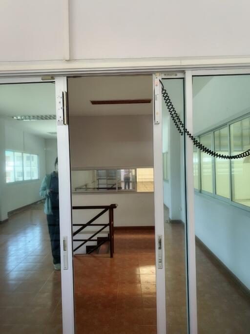 Interior view of an office or commercial space with mirrored doors and large windows