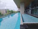 Outdoor swimming pool with adjacent building and seating area