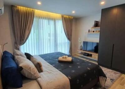 Modern furnished bedroom with large window