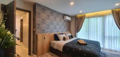 Modern bedroom with decorative wallpaper, double bed, and large window with curtains