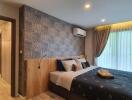 Modern bedroom with decorative wallpaper, double bed, and large window with curtains