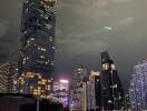 Cityscape view of high-rise buildings with illuminated lights at night