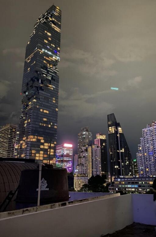 Cityscape view of high-rise buildings with illuminated lights at night