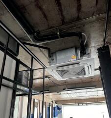 Ceiling with exposed ductwork and air conditioning unit