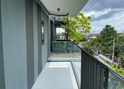 Spacious balcony with tiled floor and glass railing