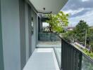 Spacious balcony with tiled floor and glass railing