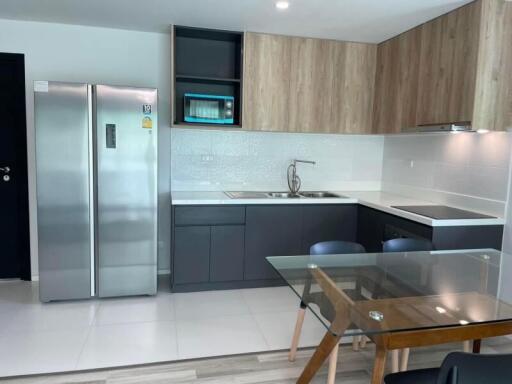 Modern kitchen with integrated appliances and glass dining table