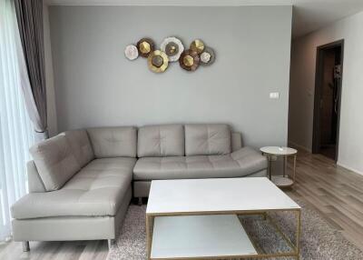 Living room with gray sectional sofa and modern decor